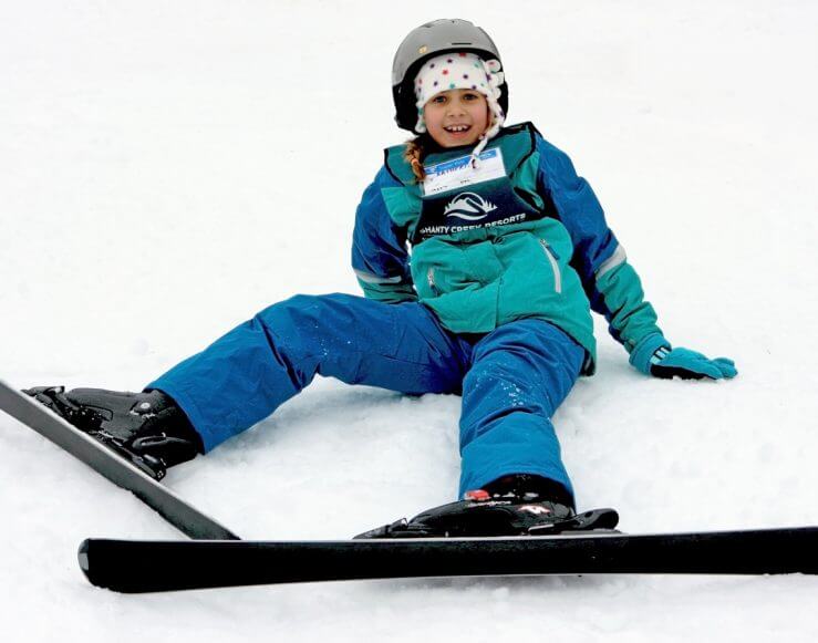 child taking ski lessons