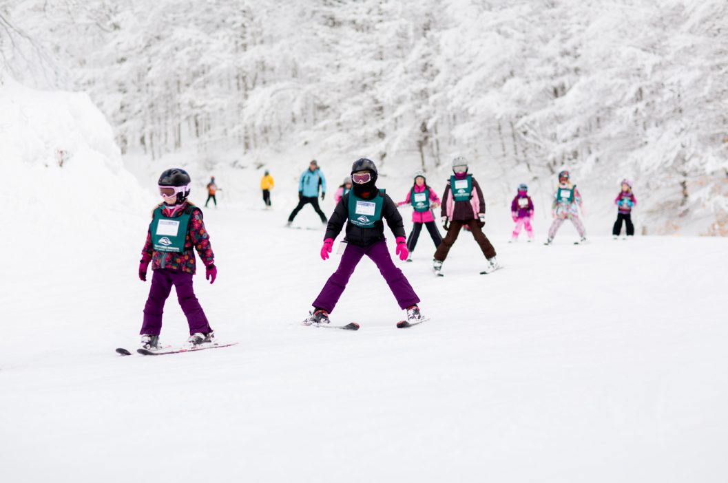 children taking ski lessons