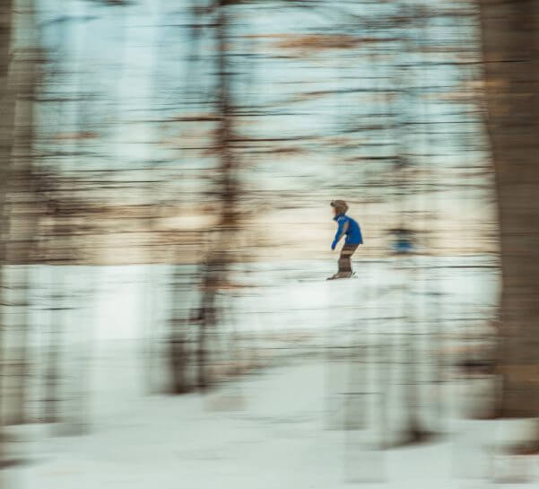 Boy skiing in the trees