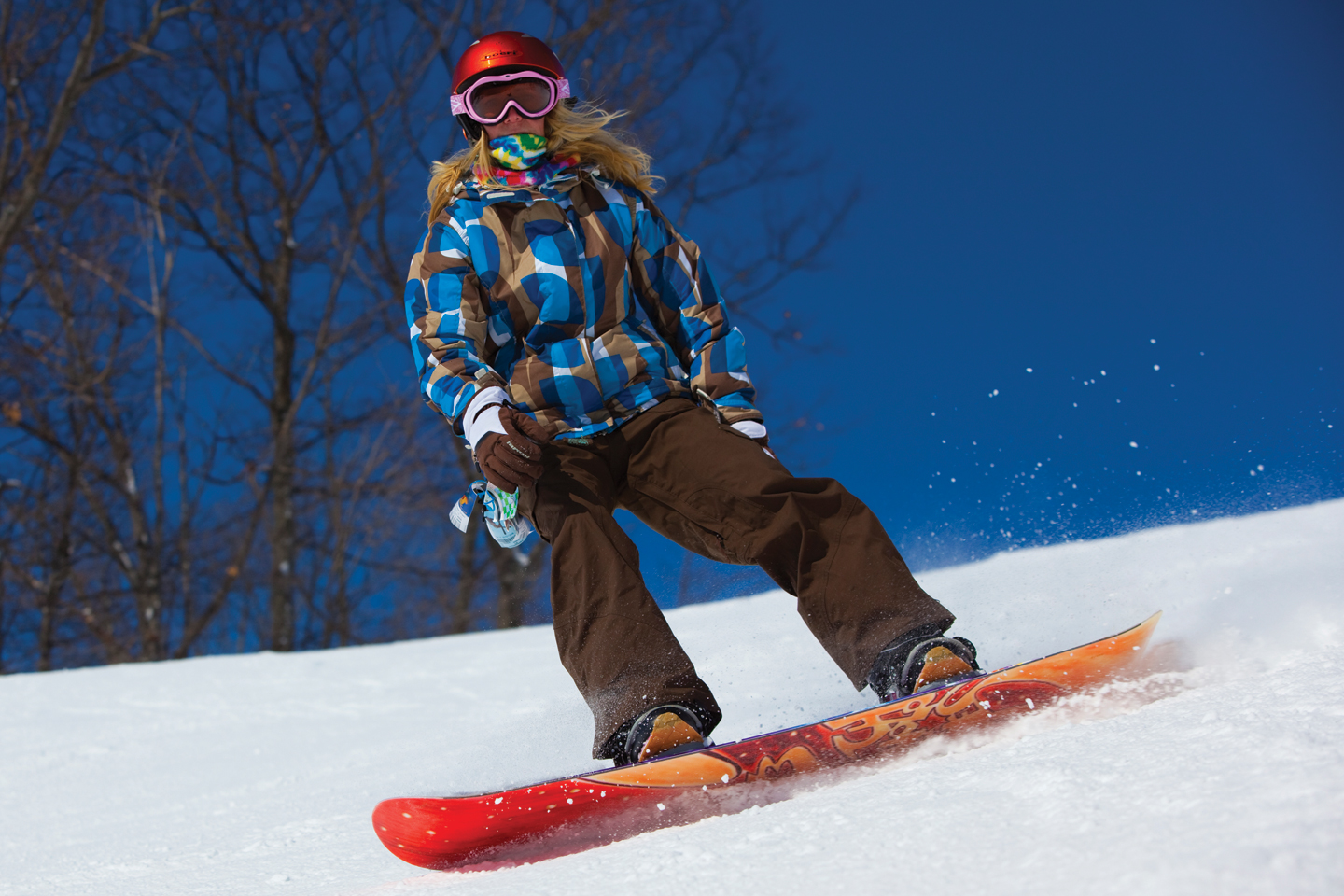 Female snowboarder in blue and brown