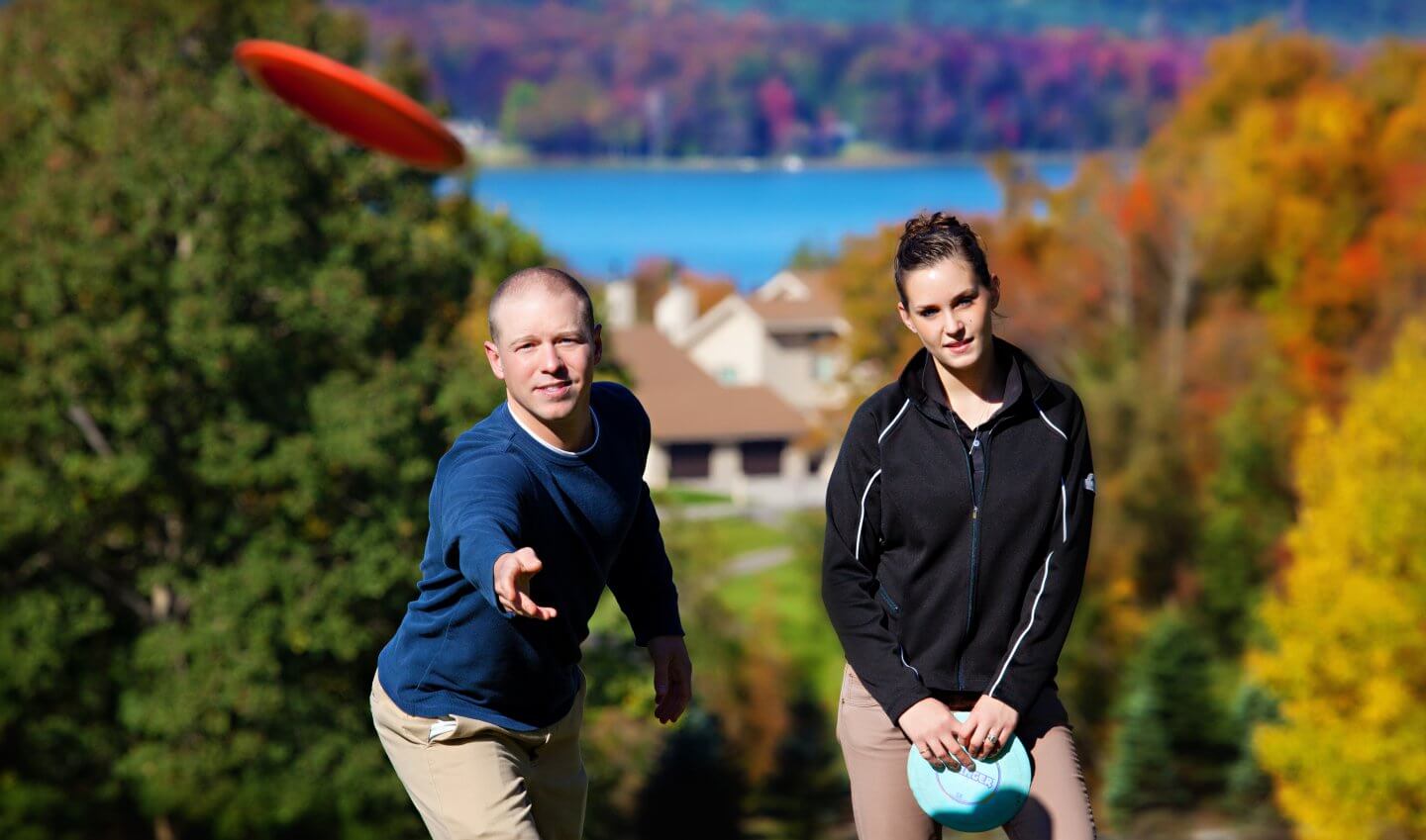 Couple Disc Golfing in the Fall Colors at Summit Mtn