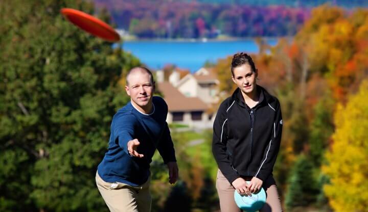 Couple Disc Golfing in the Fall Colors at Summit Mtn