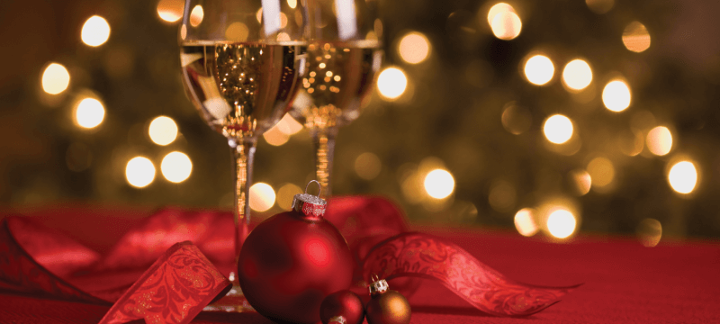 Wine and Ornaments in a Holiday Setting