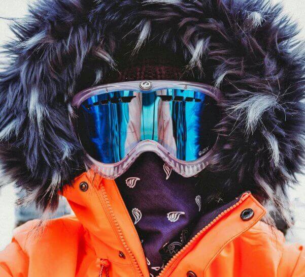 Close up of woman skier's goggled face.