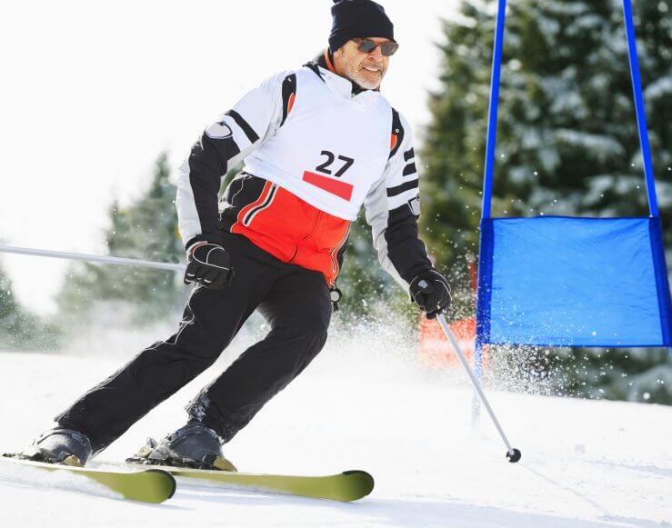 Senior man snow ski racing.