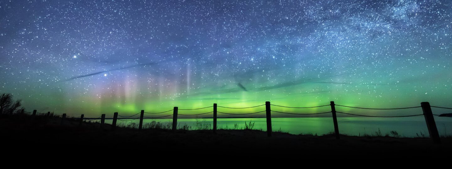 Northern Lights above in Bellaire Michigan. Photo by Heather Higham, SnapHappyGal.