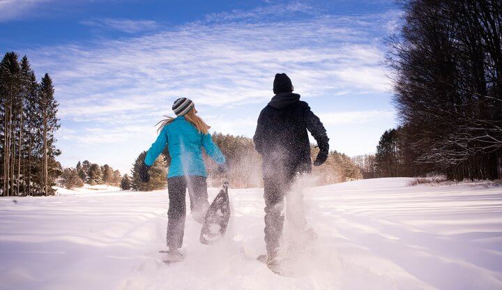 A couple snowshoeing
