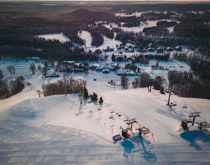 An aerial shot of the top of the yellow and blue chairlift at Schuss Mountain