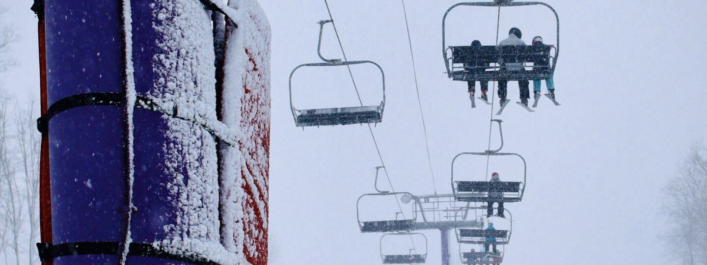 Snowy day on purple chairlift at Schuss Mountain