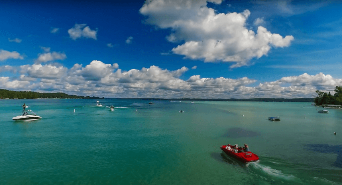 Torch Lake with red boat in foreground