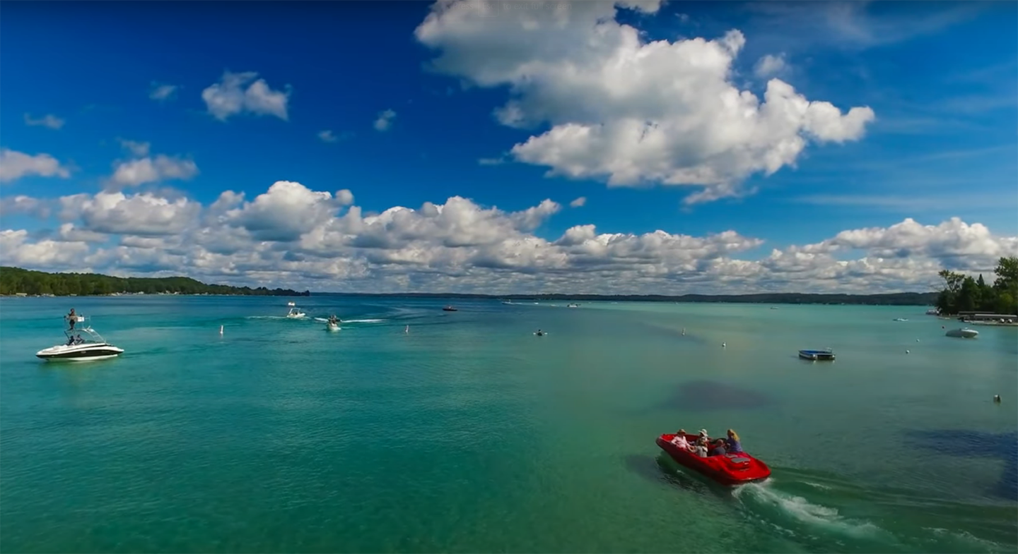 Torch Lake with red boat in foreground