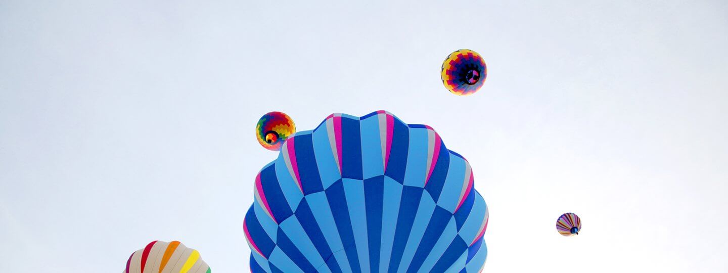 Multi-colored hot air balloons in the sky during Balloons Over Bellaire