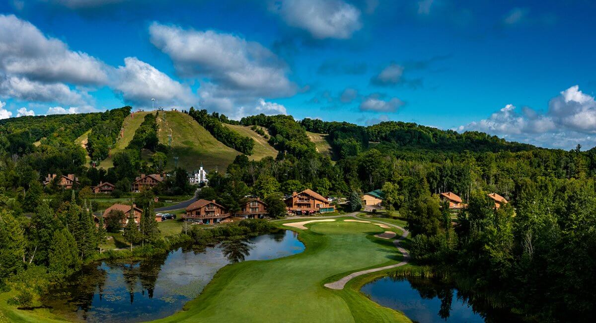 Schuss Mountain GC Hole #18 - Looking from fairway to the green with Schuss Mountain in the background