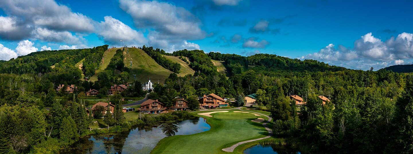 Schuss Mountain GC Hole #18 - Looking from fairway to the green with Schuss Mountain in the background