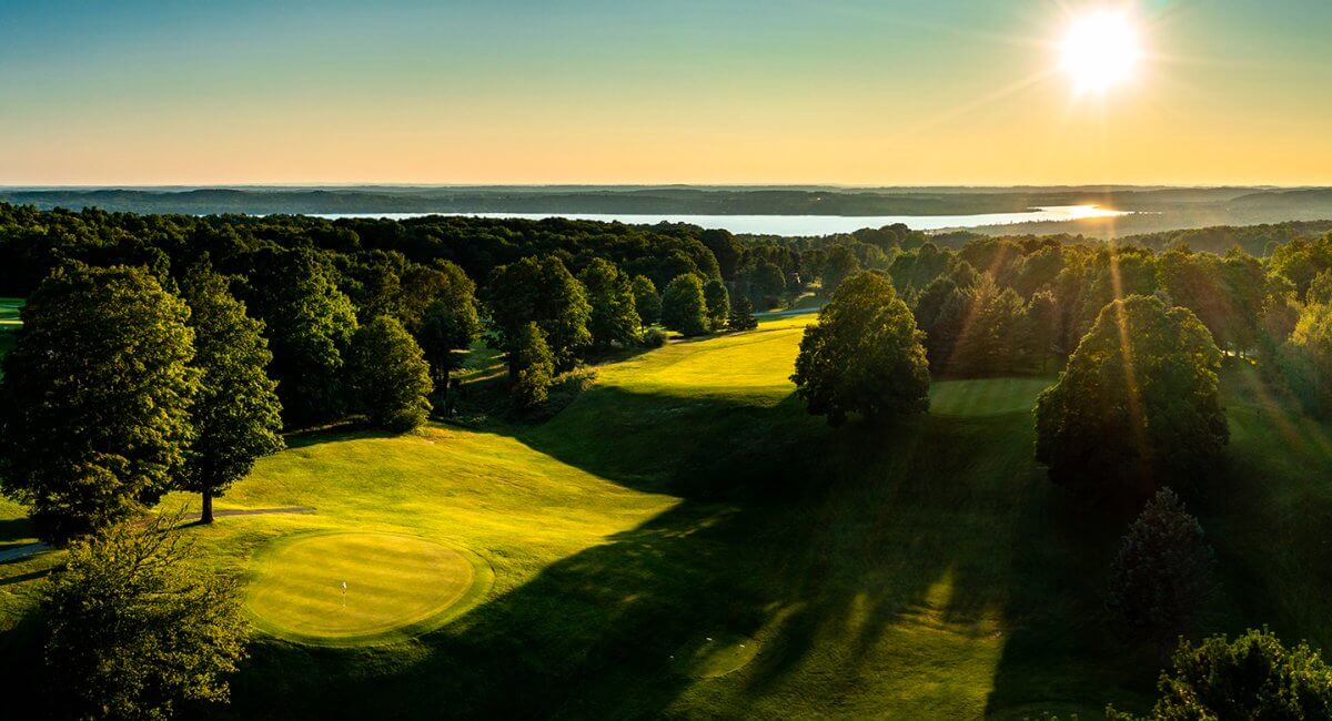 Aerial of Summit GC Hole #11 Green and Hole #12 Tee looking towards Lake Bellaire in the background