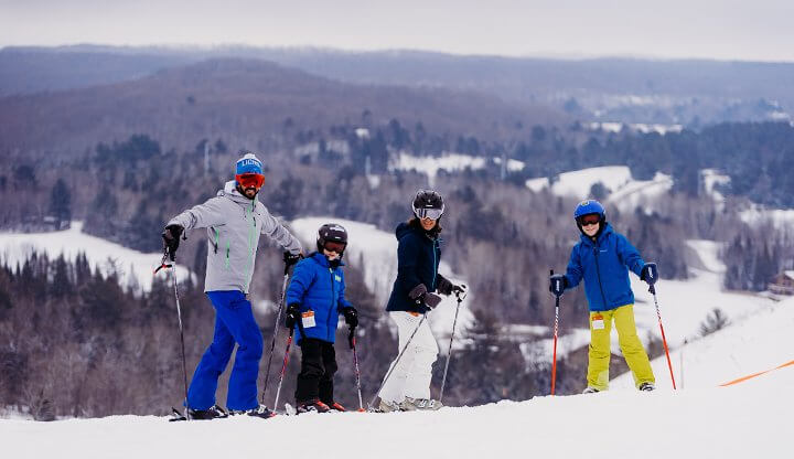 Family Standing on the top of Schuss Mountain