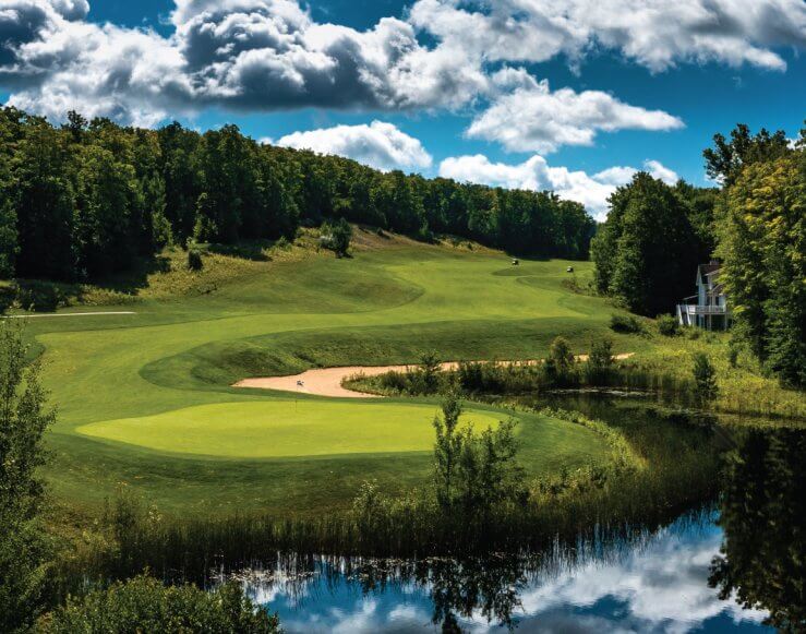 Hawk's Eye GC Hole #7's peninsula green surrounded by a pond