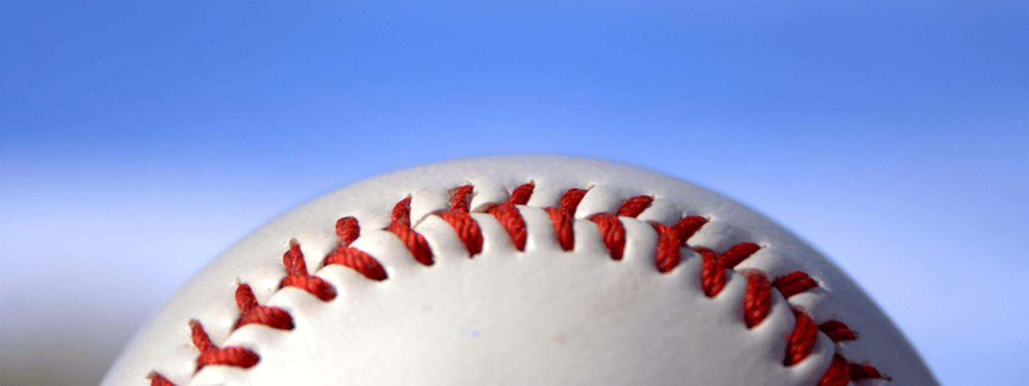 Zoomed in Photo of Baseball against a blue sky