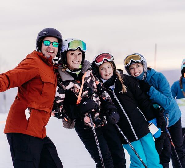 Family grouped together at top of the mountain