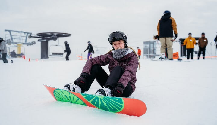 snowboarder sitting on top of the mountain