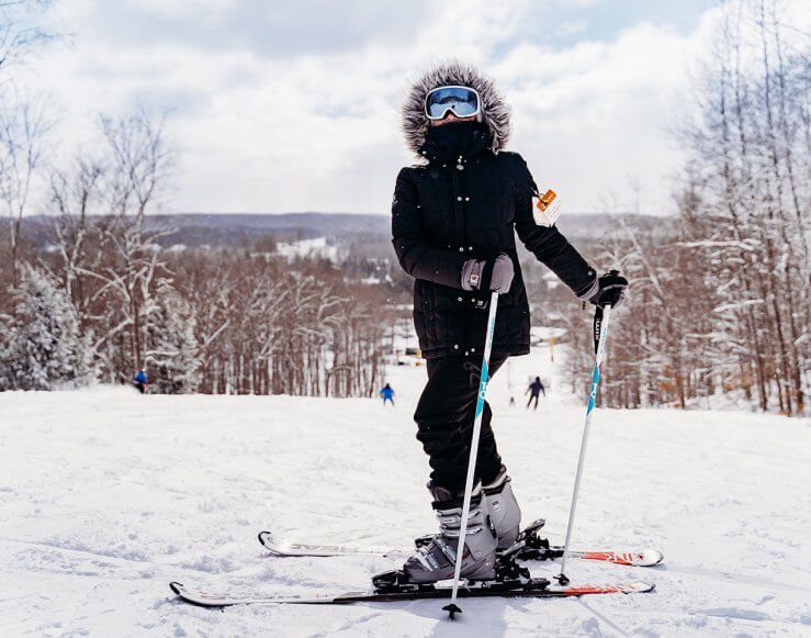 Skier in Black gets ready go down the slope