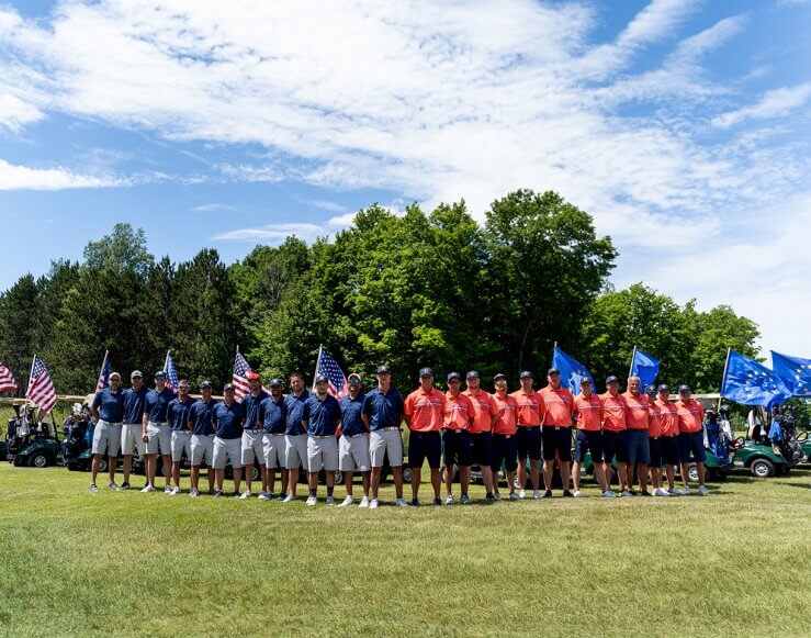 Group of Golfers in red and blue shirts standing in front of their carts