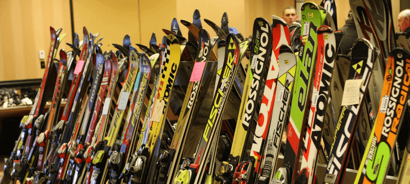 A line of various skis for sale at the Antrim Ski Academy Ski Swap