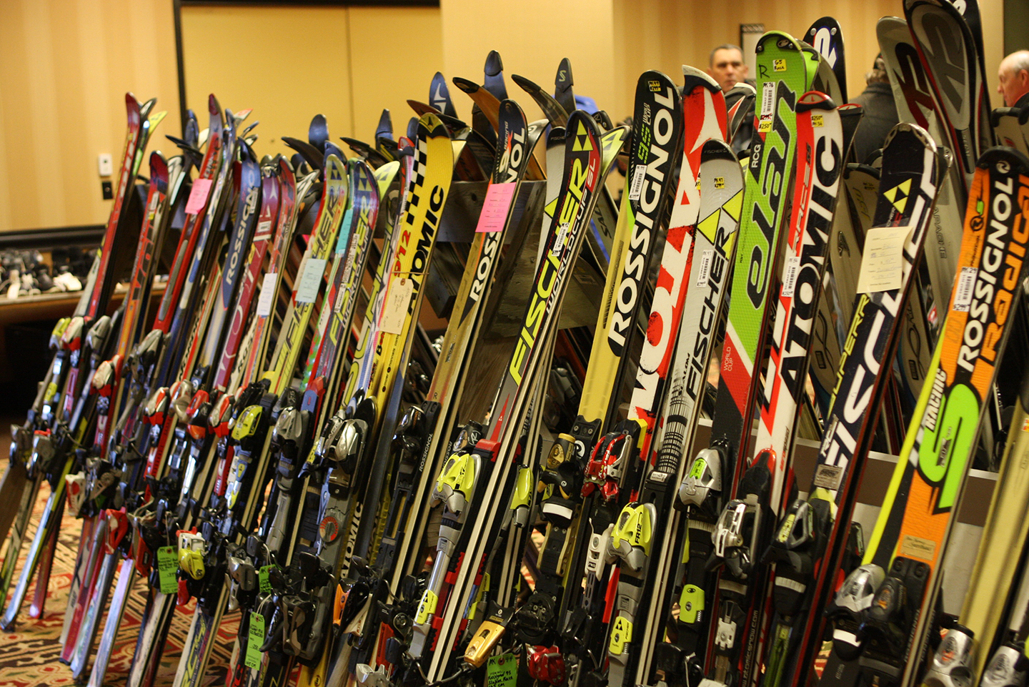 A line of various skis for sale at the Antrim Ski Academy Ski Swap