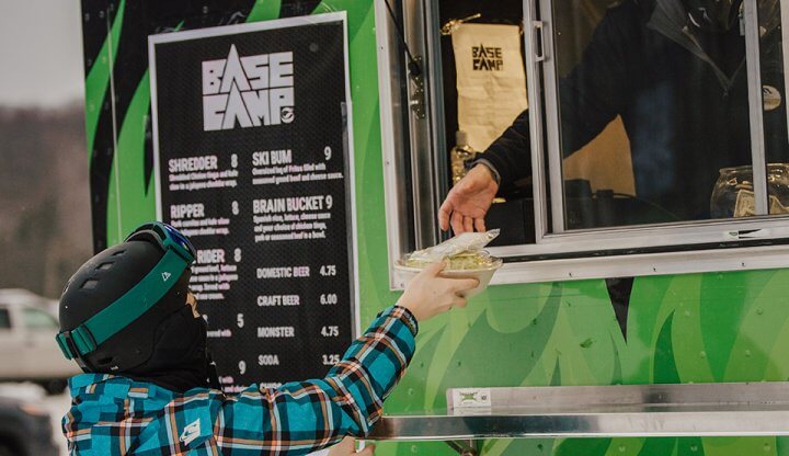 Skier being handed their meal from the Base Camp Food Truck