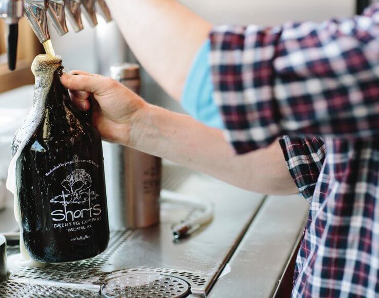 Shorts-Brewing-Filling-A-Growler-Of-Beer