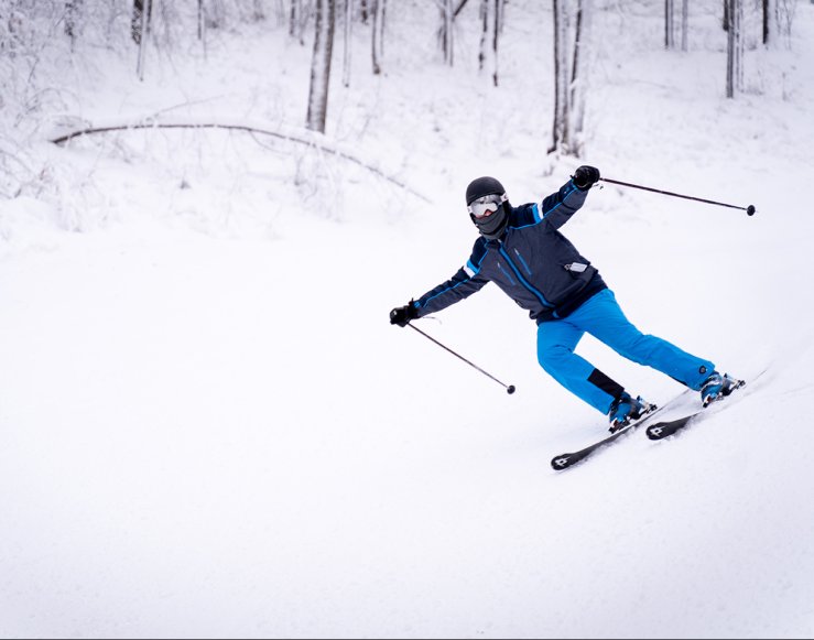 photo of a blue jacket skier