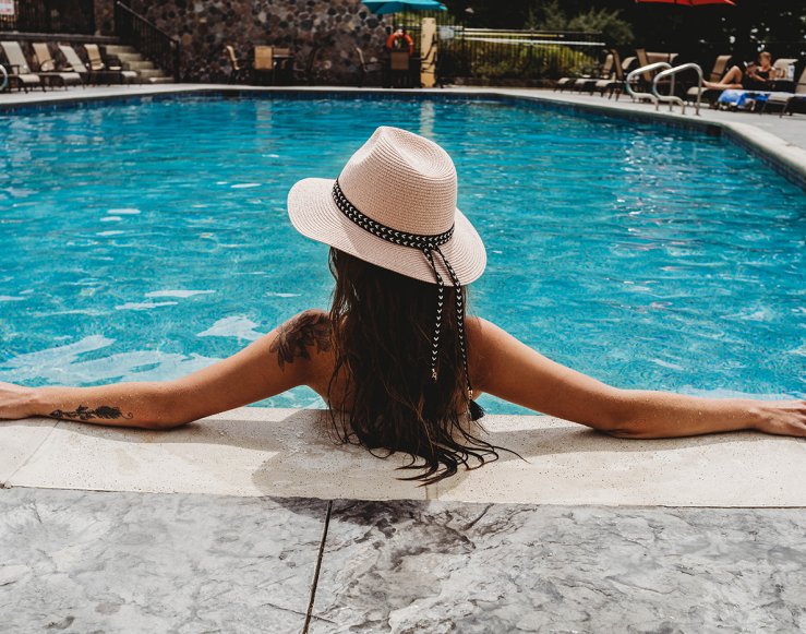 Back of a woman soaking in the Lakeview Hotel Outdoor Pool