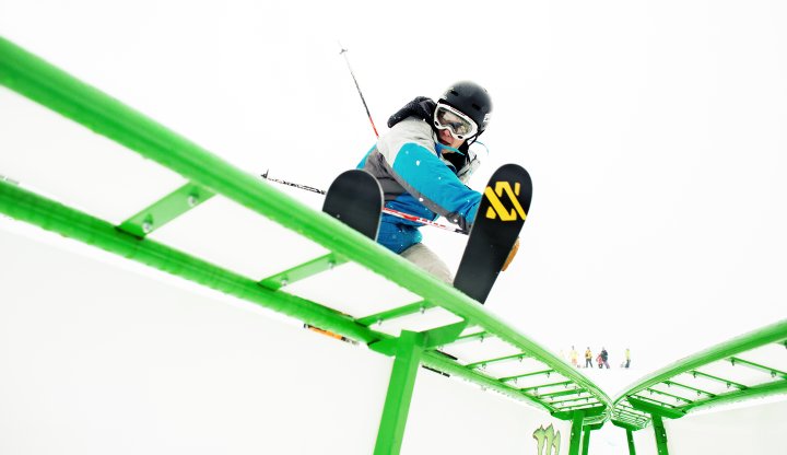 Skier on S-Curve Rail in Purple Daze Terrain Park