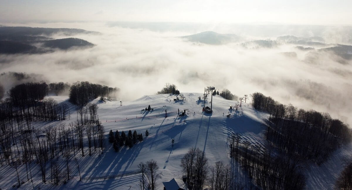 The Top of snow-covered Schuss Mountain in the winter with fog