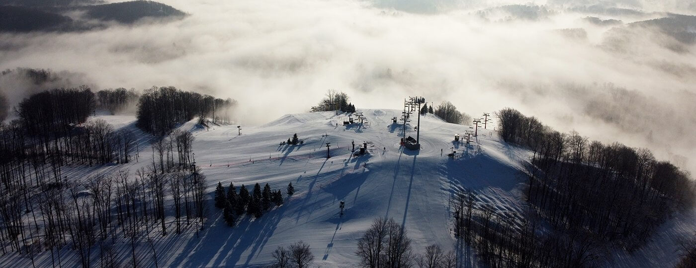 The Top of snow-covered Schuss Mountain in the winter with fog