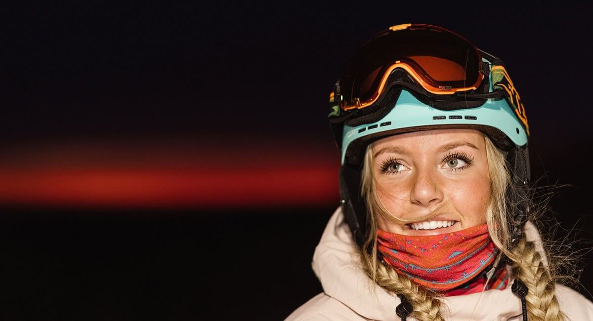 Portrait of a Female Snowboarder with the Night Sky behind her
