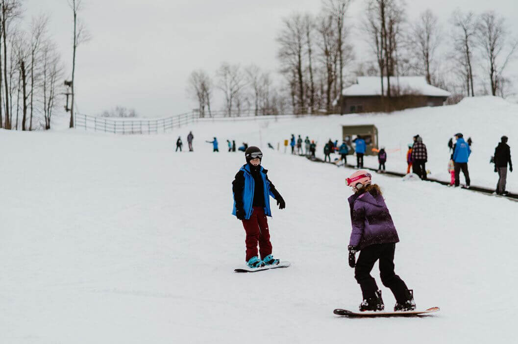 Snowboard Instructor with Student Snowboarder next to the Magic Carpet at Schuss Mountain