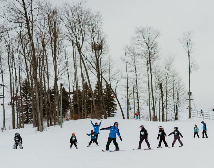 Shanty Creek Ski Instructors show many children how to ski down the bunny hill