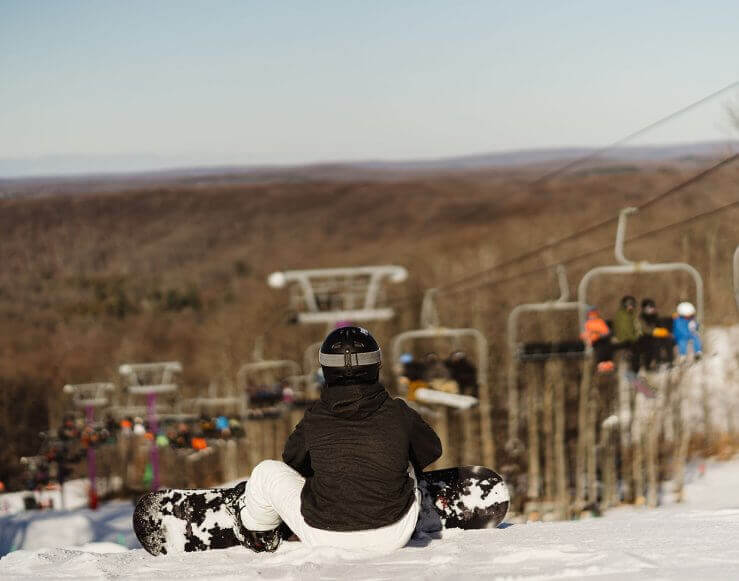 Snowboarder at the top of Purple Daze admiring the view