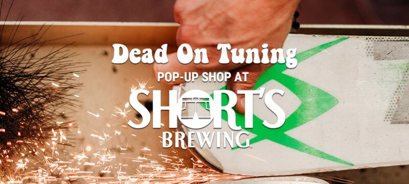 Dead On Tuning Pop Up Shop at Short's Brewing with a hand sharpening a ski