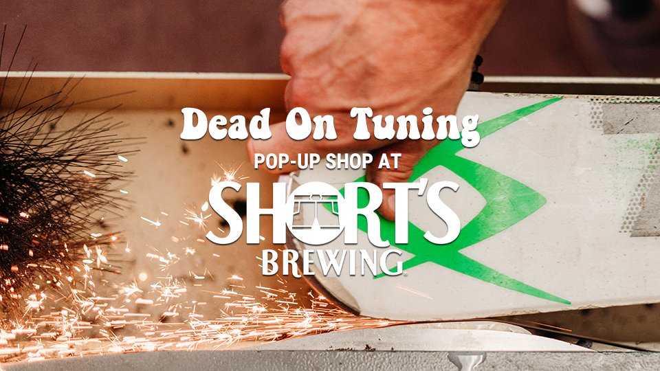 Dead On Tuning Pop Up Shop at Short's Brewing with a hand sharpening a ski