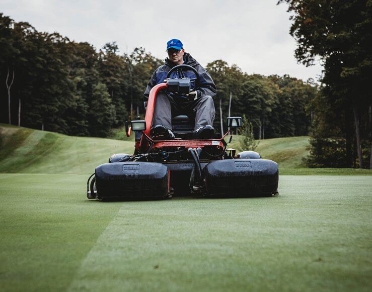 Shanty Creek Employee Mowing Fairway of Golf Course