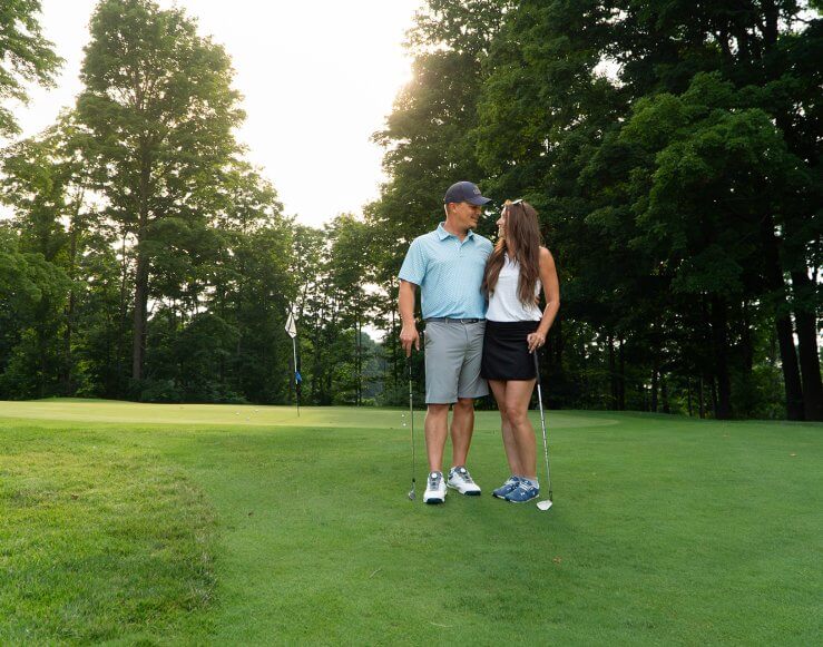 Golfing Couple Poses in front of Green