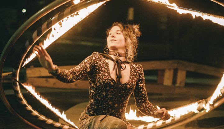 Performing holding a firey Cyr wheel.